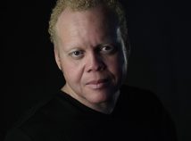 Profile photo of faculty member Charles Nuckolls in a closeup with a black background and wearing a black shirt that blends into the background creating a dramatic look.