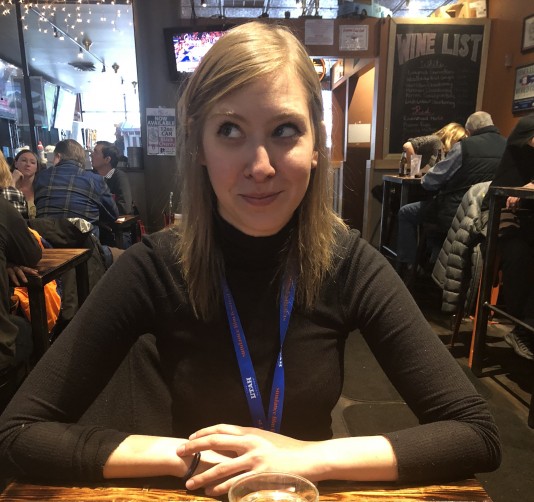 Bennett Elliott sits at a table wearing a black shirt.