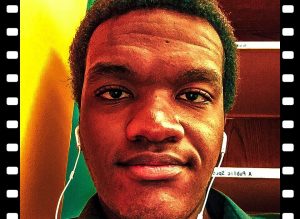high saturated profile picture of Lanre looking at the camera with iphone headphones in his ears and fake film strip effects on the side of the image.