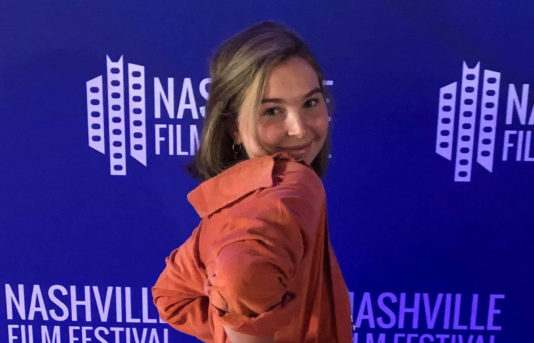 SVA Student Ava Young in front of banner for Nashville Film festival
