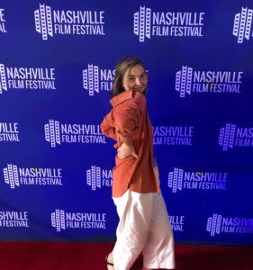 SVA Student Ava Young in front of banner for Nashville Film festival