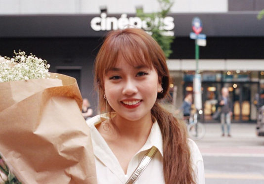 Bouquet Nappusorn standing outside cinepolis with bouquet of flowers