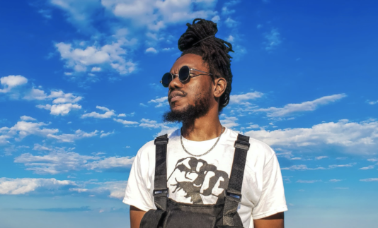 profile photo of Sage Love in front of a cloudy blue sky