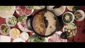 Still from Yoko Chen's short essay film shows a ton of ingredients being prepared for a hotpot feast