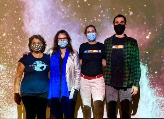 Nana Simopoulos (left) stands with the other creators of the exhibit in front of a starry backdrop from the installation.