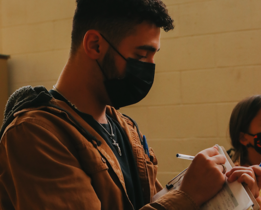 Joseph Rana taking notes on set.