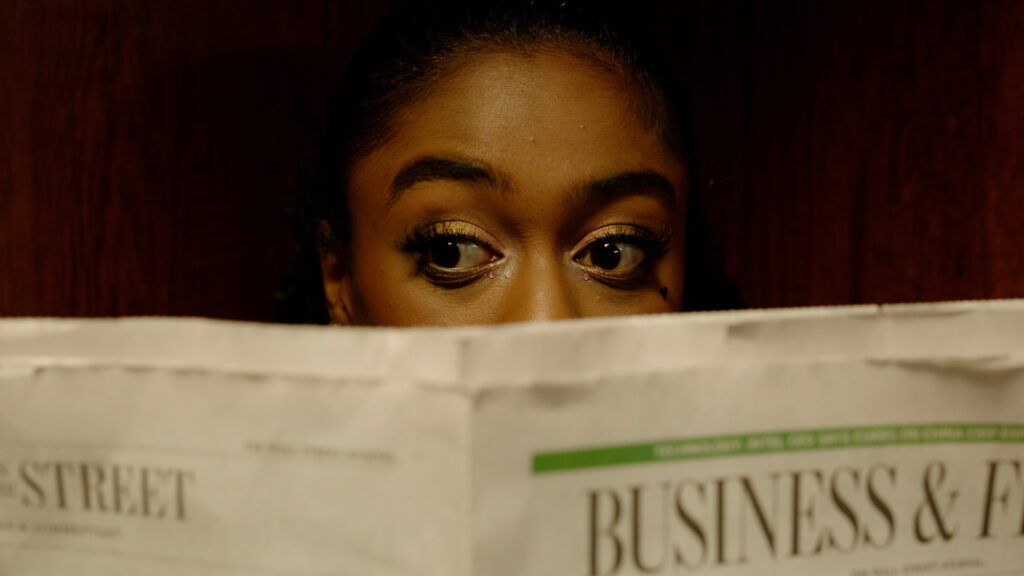 A closeup of a person reading a newspaper.