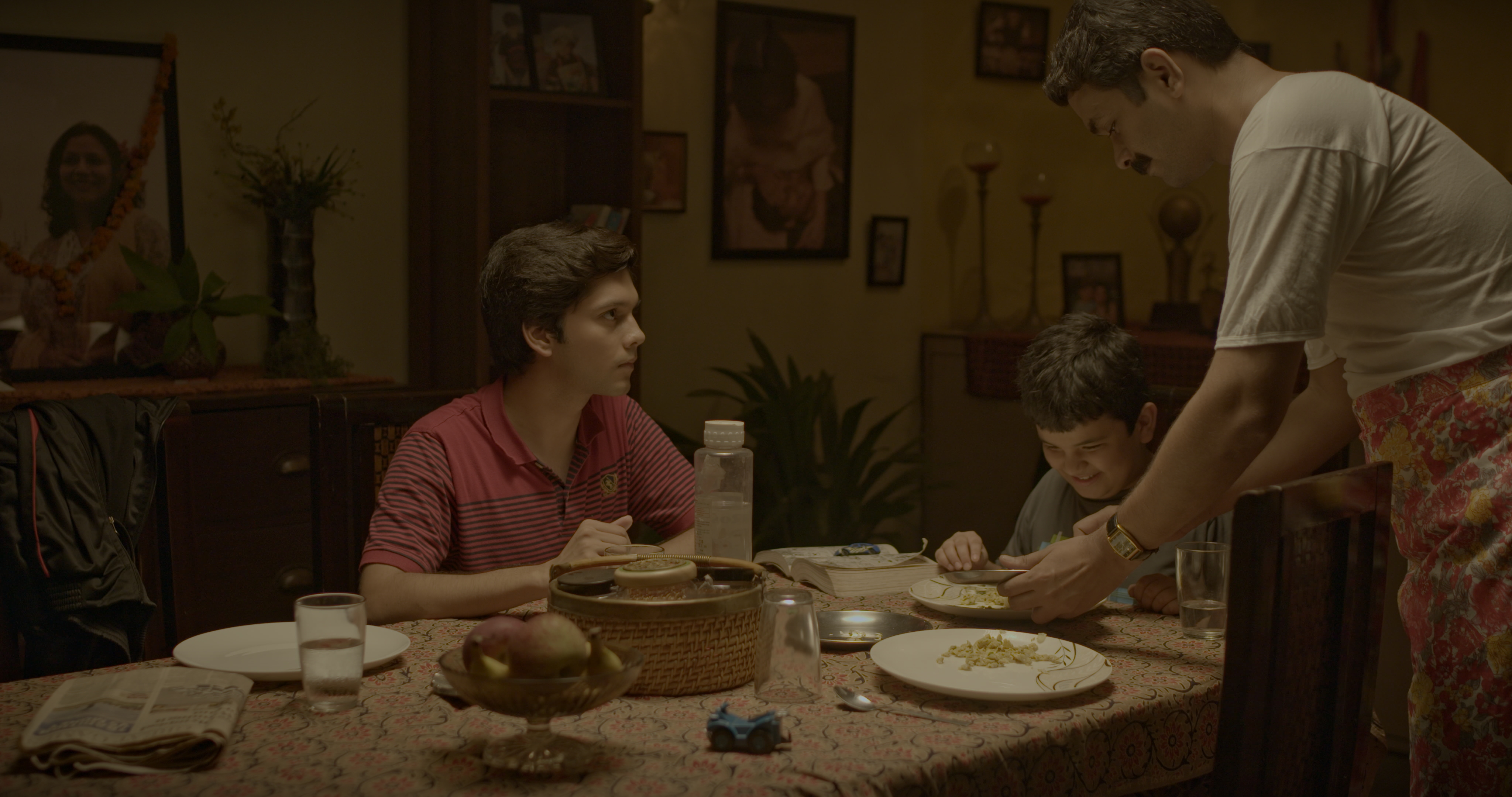 Still Image from Subah showing the cast gathered around a table with food.