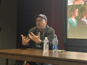 Barbie Editor Nick Houy speaking at a table in our theater room 502