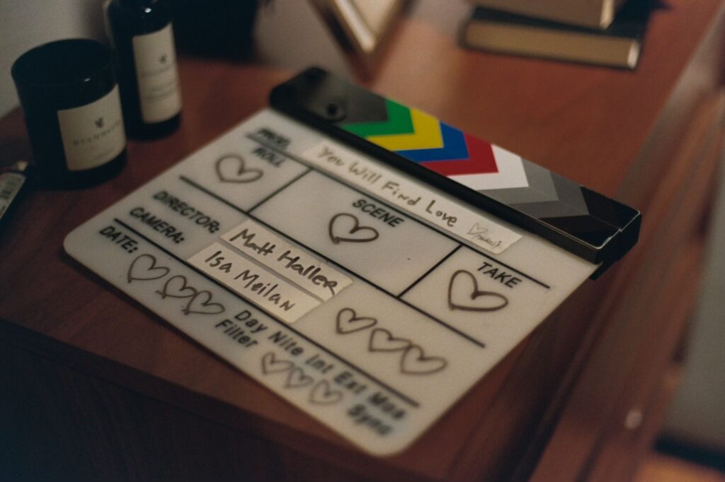 A clapperboard for You Will Find Love. The director is Matt Haller and camera is Isa Meilan. Instead of other information, all squares are filled with hearts.