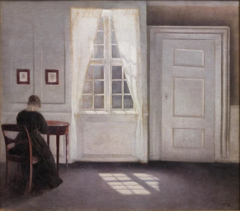 A painting of a woman dressed in a black dress, sitting on the far left corner of the canvas with her back to the visualizer. She looks down at a table. In the middle of the painting there is a open window that lights up the scene.