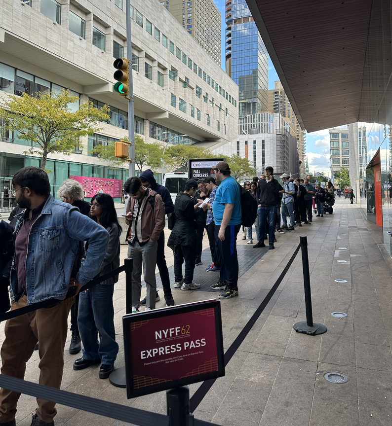 festival goers standing in line for the NYFF 'express pass' line . 