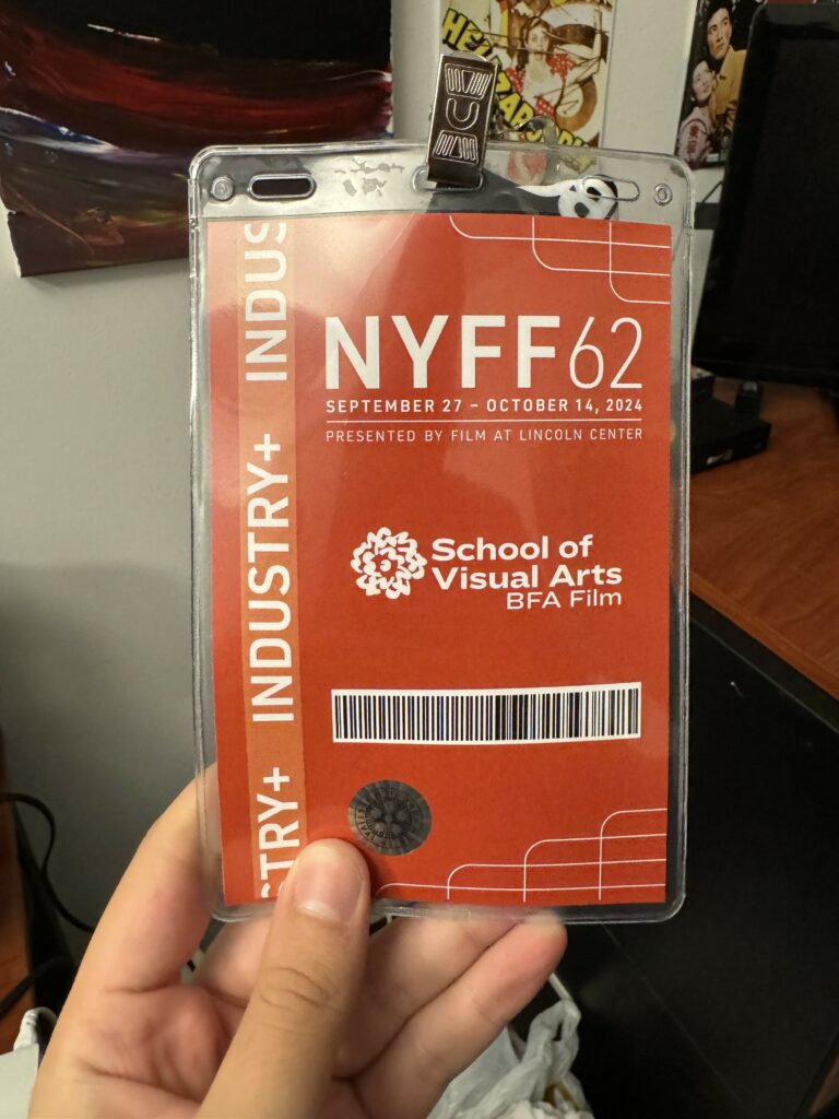 Photo of a hand holding up an Industry+ pass for the 62nd NYFF Film FESTIVAL. The pass is labeled “School of Visual Arts BFA Film.”