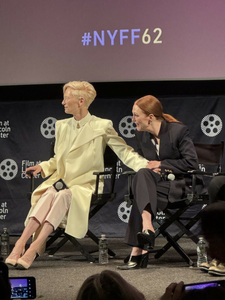 Photo of Tilda Swinton and Julianne Moore sitting beside each other onstage for a Q&A at the 62nd New York Film Festival.